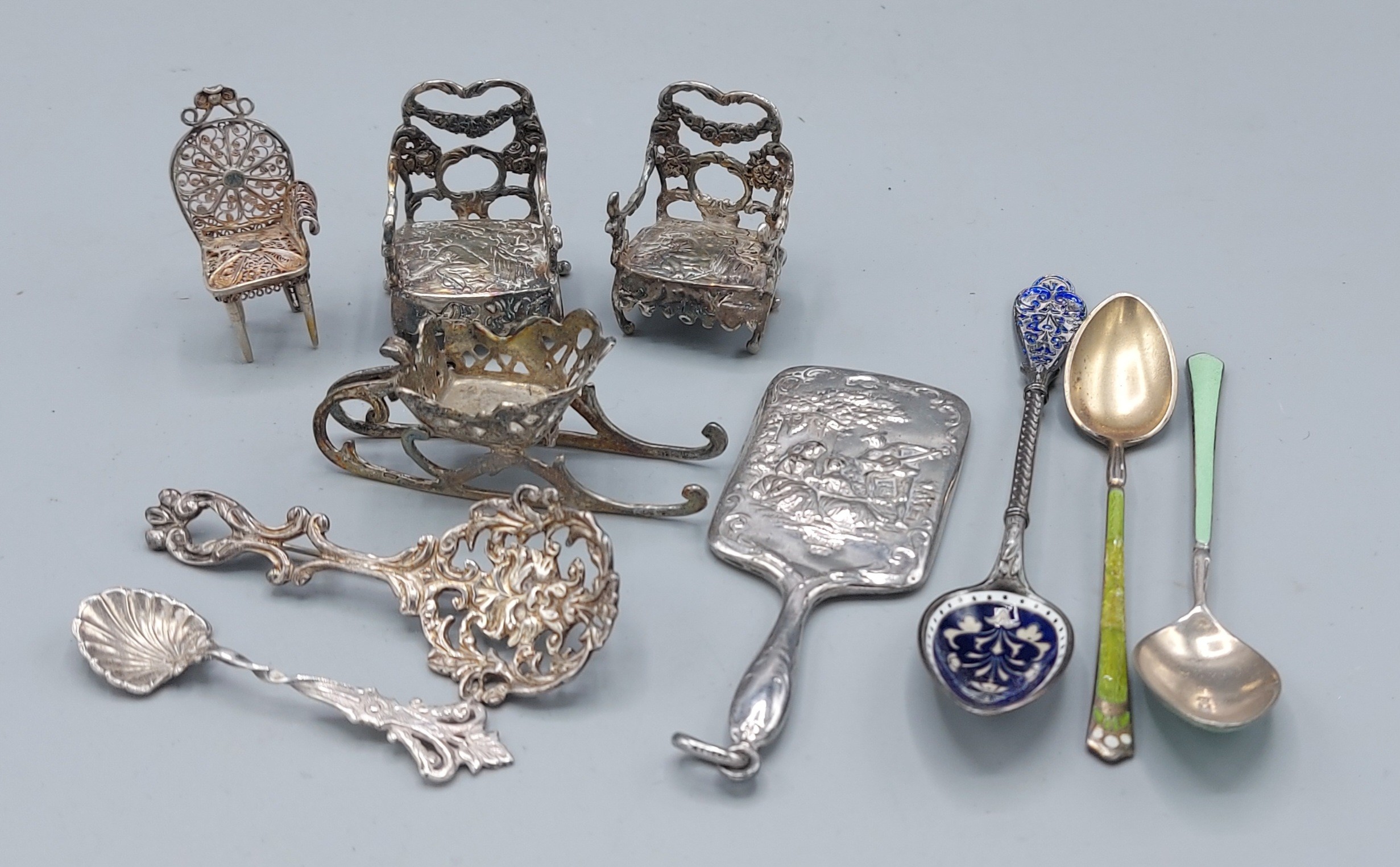A Sterling silver miniature hand mirror together with a collection of foreign white metal to include