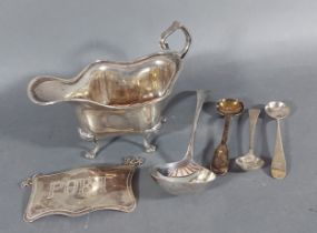 A Sheffield silver jug together with a London silver decanter label, three silver mustard spoons and
