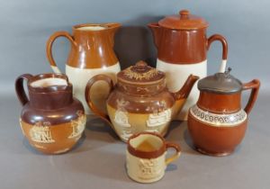 A Doulton Lambeth stoneware harvest teapot together with a similar jug, three other stoneware