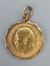 An Edwardian gold half Sovereign dated 1911 within 9ct gold pendant mount