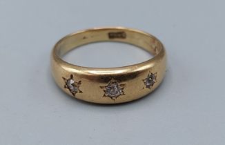 A yellow metal three stone Diamond ring, 2.5gms, ring size K