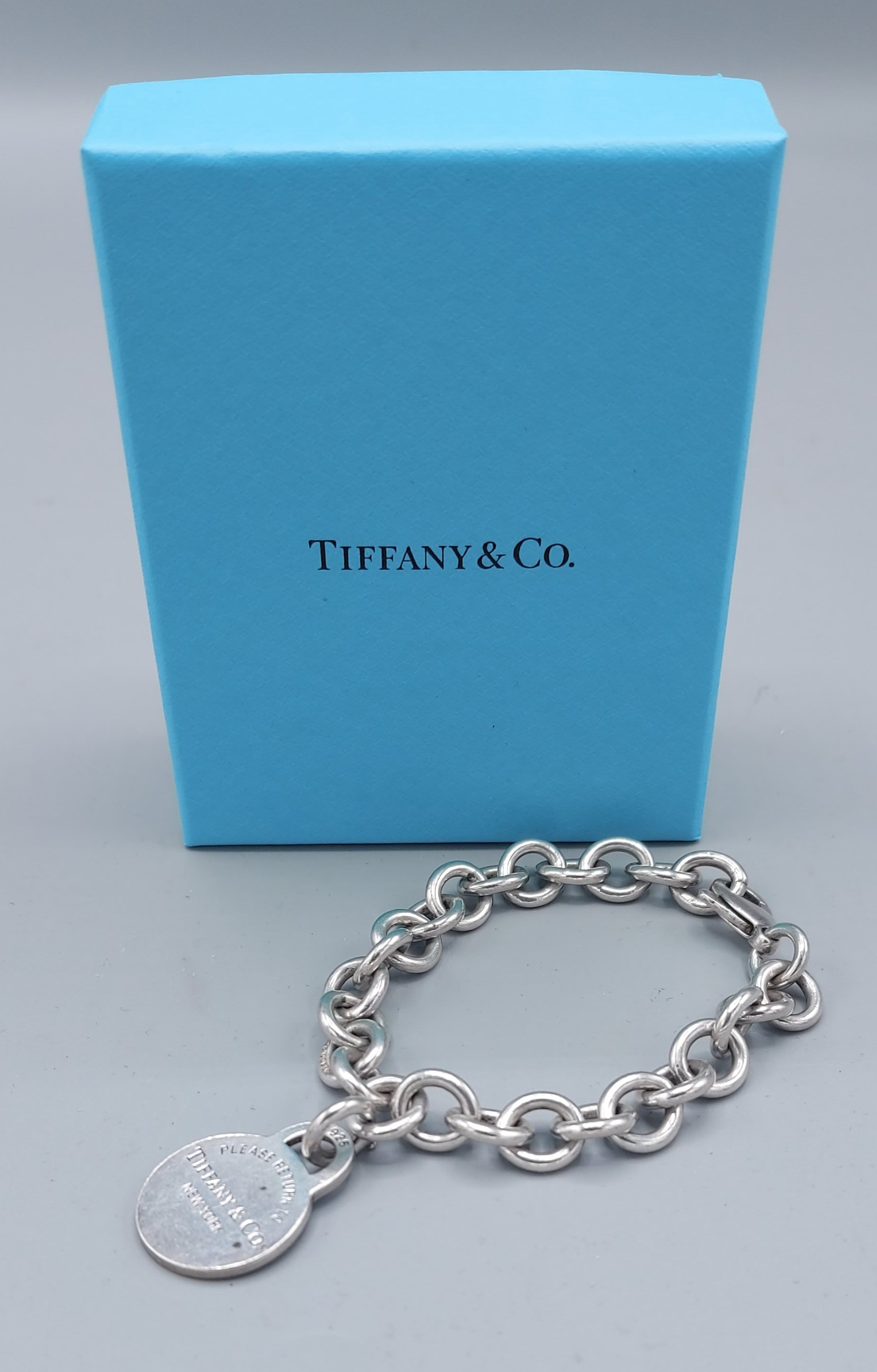 Tiffany and Co. a 925 silver linked bracelet with circular tab inscribed Please Return To Tiffany