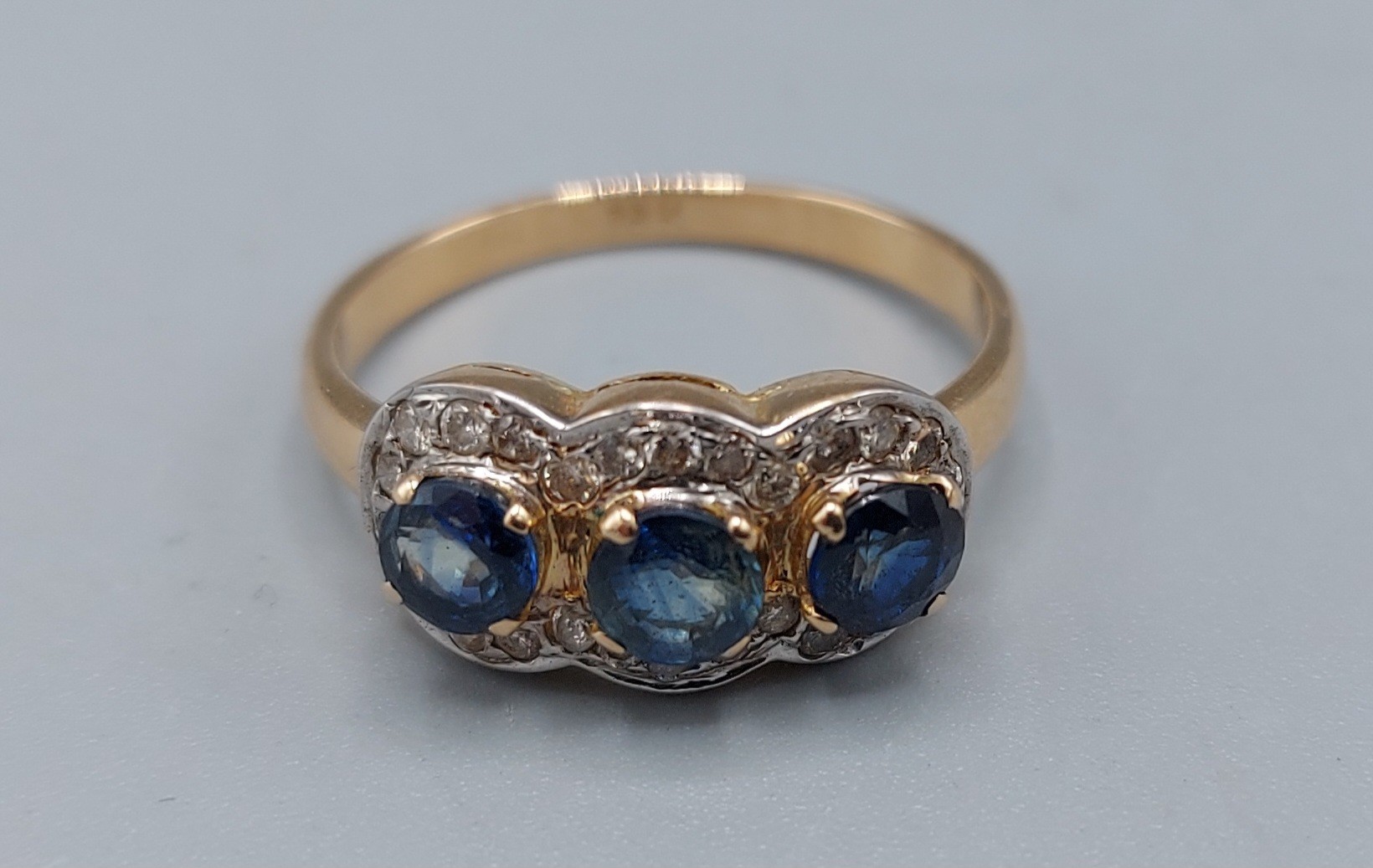 An 18ct gold Diamond and Sapphire triple cluster ring, 3.7gms, ring size O