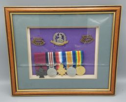 A group of three Royal Norfolk cap badges together with a replica medal group of five 1st World