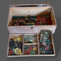 A collection of early Meccano within a pine box