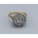 An 18ct gold Diamond cluster ring with a central Diamond surrounded by Diamonds, 4.7gms, ring size I