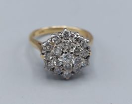An 18ct gold Diamond cluster ring with a central Diamond surrounded by Diamonds, 4.7gms, ring size I