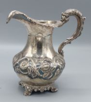 A Victorian silver jug of bulbous embossed form, London 1844, maker William Hunter, 9ozs