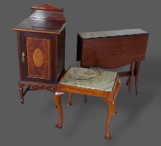 An Edwardian mahogany bedside cupboard together with a Sutherland table, a marble topped side