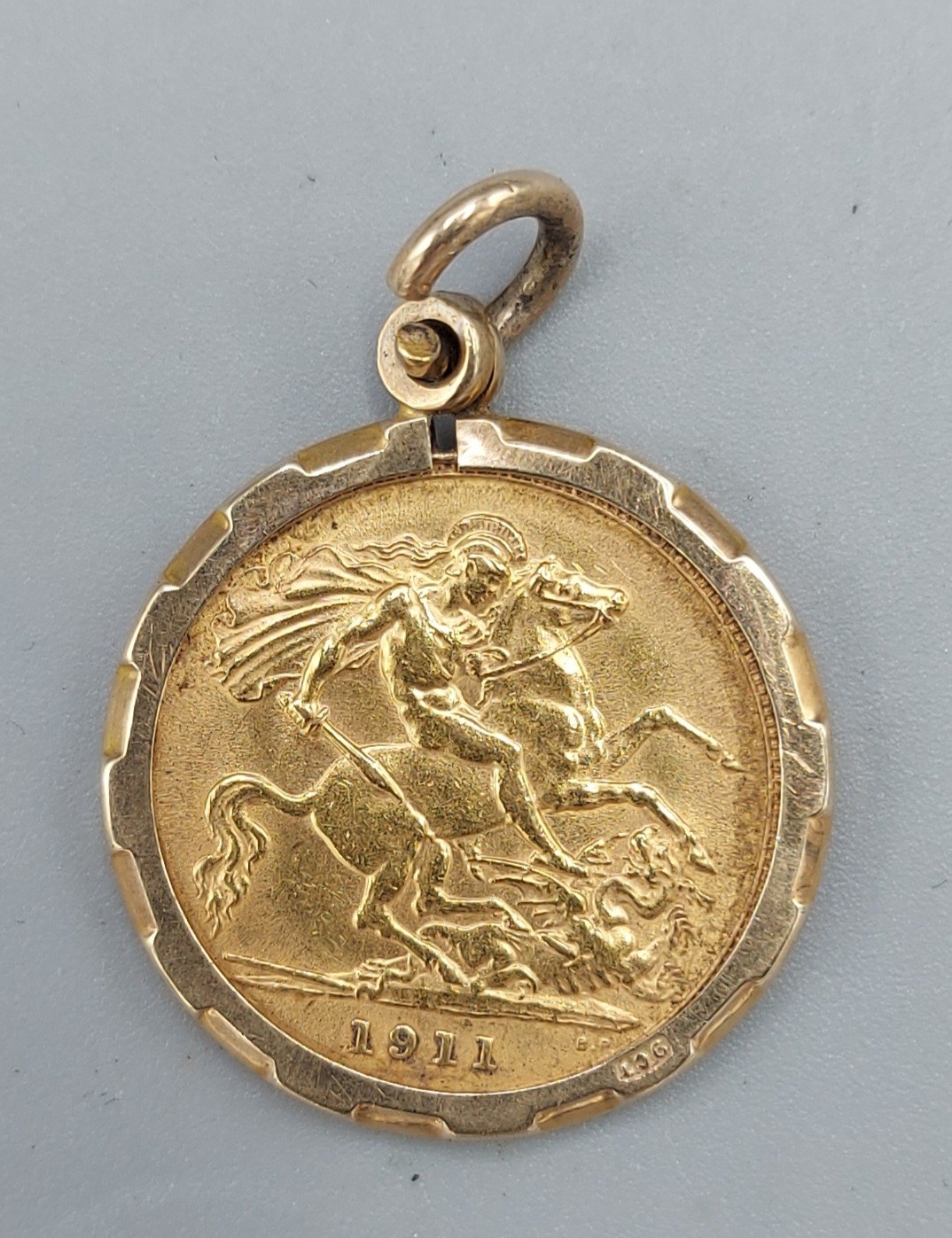 An Edwardian gold half Sovereign dated 1911 within 9ct gold pendant mount - Image 2 of 2