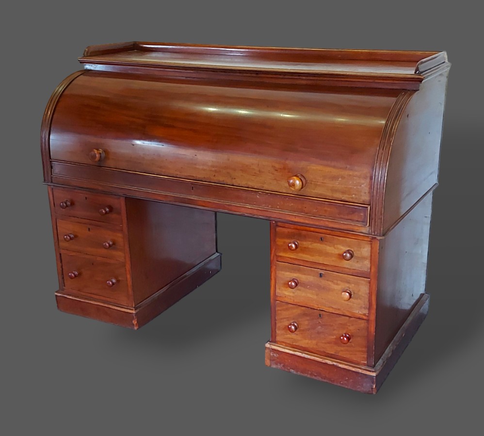 A Victorian mahogany twin pedestal cylinder desk, the fitted top above six drawers with knob handles