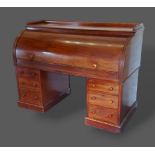 A Victorian mahogany twin pedestal cylinder desk, the fitted top above six drawers with knob handles