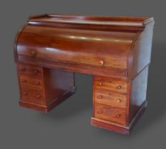 A Victorian mahogany twin pedestal cylinder desk, the fitted top above six drawers with knob handles