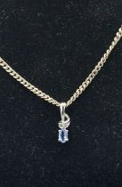 A 9ct white gold Diamond and Topaz set pendant with 925 silver chain