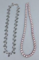 A pink pearl necklace with silver clasp together with a silver marcasite necklace