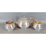 An Art Deco London silver three piece tea service comprising, teapot, cream jug and two handled