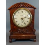 A William IV mahogany cased bracket clock with carved and shaped case,the circular enamel dial