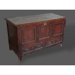 A George III pine Mule chest with a hinged top above a three panel front and two drawers flanked