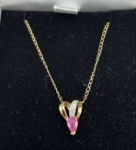 A 9ct gold Ruby and Diamond set pendant together with a 9ct gold chain with box