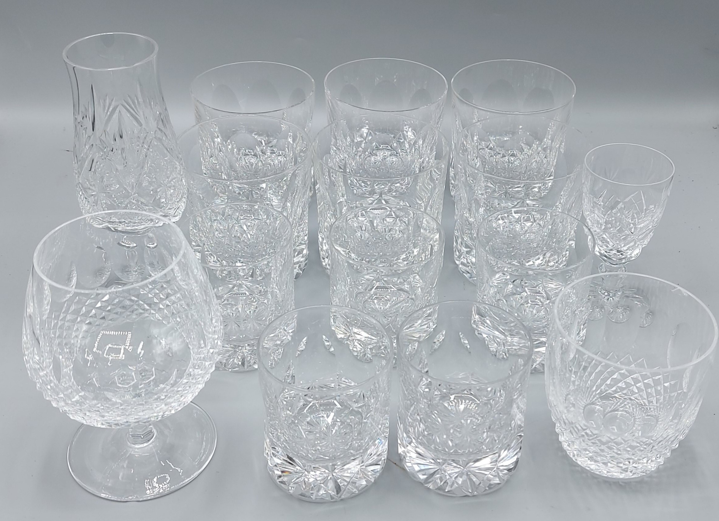A set of six glass whiskey tumblers by Tudor together with five matching smaller glasses and four