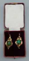 A pair of Victorian yellow metal drop earrings, each set with green stones, 4.9gms, 3cms long