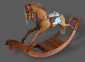 A Stevenson Brothers carved rocking horse, dated 1992, numbered 1132, 194cms long