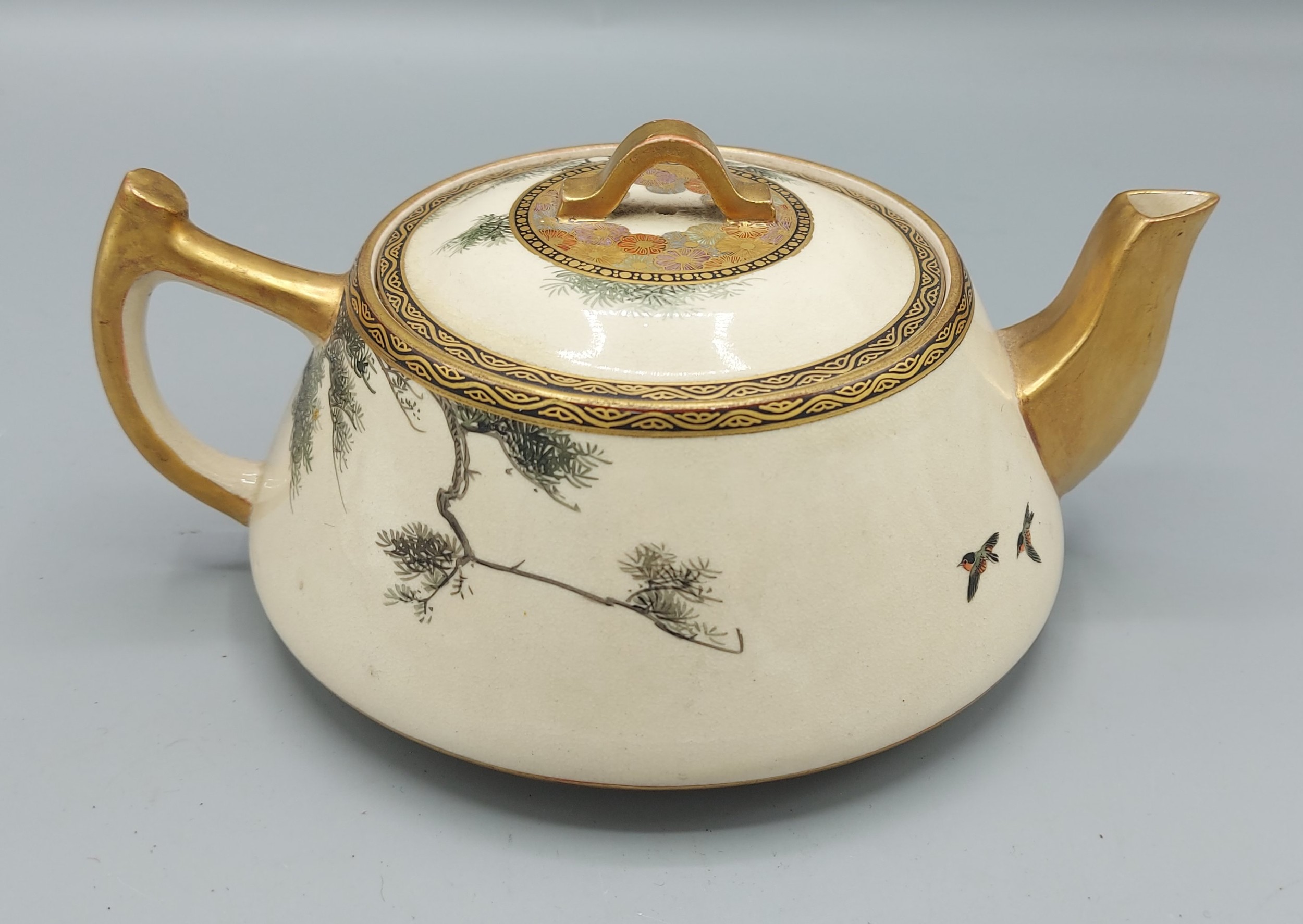 A Satsuma earthenware teapot decorated with birds amongst foliage highlighted with gilt - Image 3 of 3