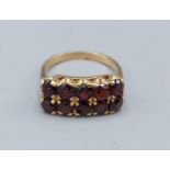 A 9ct gold ring set with two rows of five Garnets, 4.4gms, ring size M