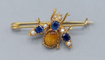 A yellow metal brooch in the form of a Bee set with Tigers Eye, Pearls and Sapphires, 2.2gms, 3cms