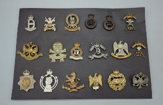 A collection of eighteen British Army Regimental cap badges to include Royal Scots Tank Corp