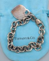A 925 silver bracelet by Tiffany and Co. with heart form tab, complete with Tiffany pouch