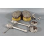 A pair of Indian white metal brushes together with a pair of Tibetan prayer Mani, two napkin rings