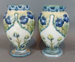 A pair of Moorcroft Macintyre vases decorated Poppy and Forget-Me-Nots, 11cms tall