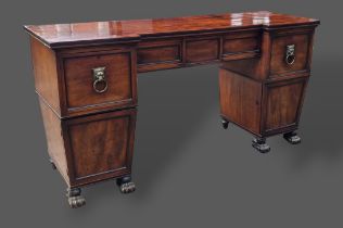 A Regency mahogany twin pedestal sideboard, the moulded top above three drawers and two cupboard