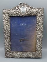 A Birmingham silver photograph frame of embossed form, 31cms x 22.5cms