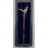 A Victorian yellow metal stick pin set with a Diamond, Ruby and enamel model of a Pheasant, 7cms