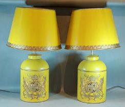 A pair of Toleware table lamps, each decorated with a gilded crest upon a Mustard groundand with