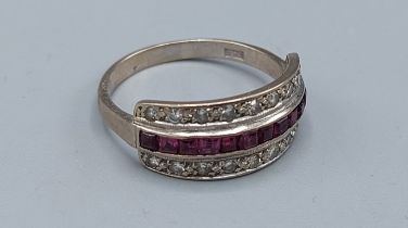 An 18ct gold ring set with a central row of Diamonds and two rows of diamonds, 4.8gms, ring size T
