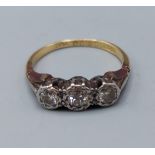 An 18ct gold and Platinum three stone Diamond ring, 2.8gms, ring size J