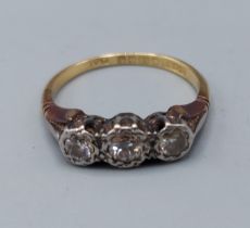 An 18ct gold and Platinum three stone Diamond ring, 2.8gms, ring size J