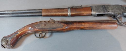 An Eastern pistol together with a copy Winchester rifle and a propeller