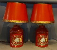 A pair of Toleware table lamps, each decorated with a crest upon a red ground together with Toleware