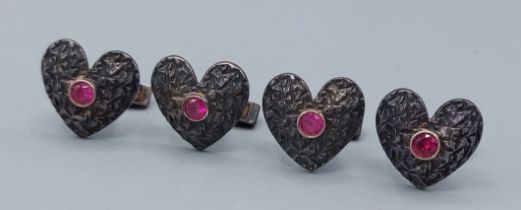 A set of four London silver cufflinks of heart form, each set with a pink stone