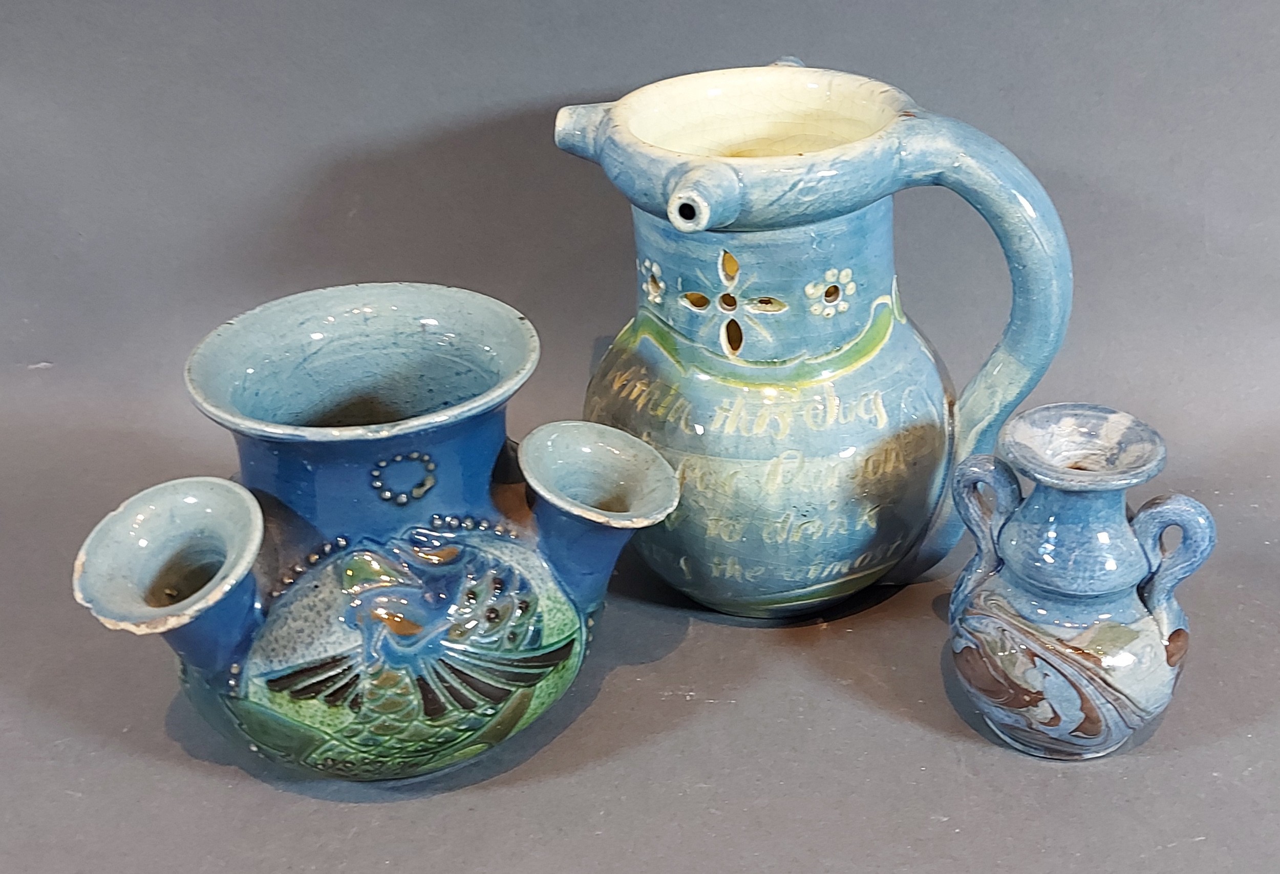 A Barum pottery jug, 13cms tall, together with two Barum pottery vases