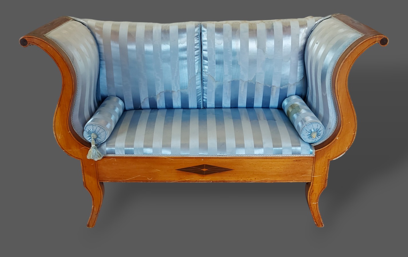 A 19th Century French boudoir sofa with shaped scroll ends above an inlaid frieze raised upon