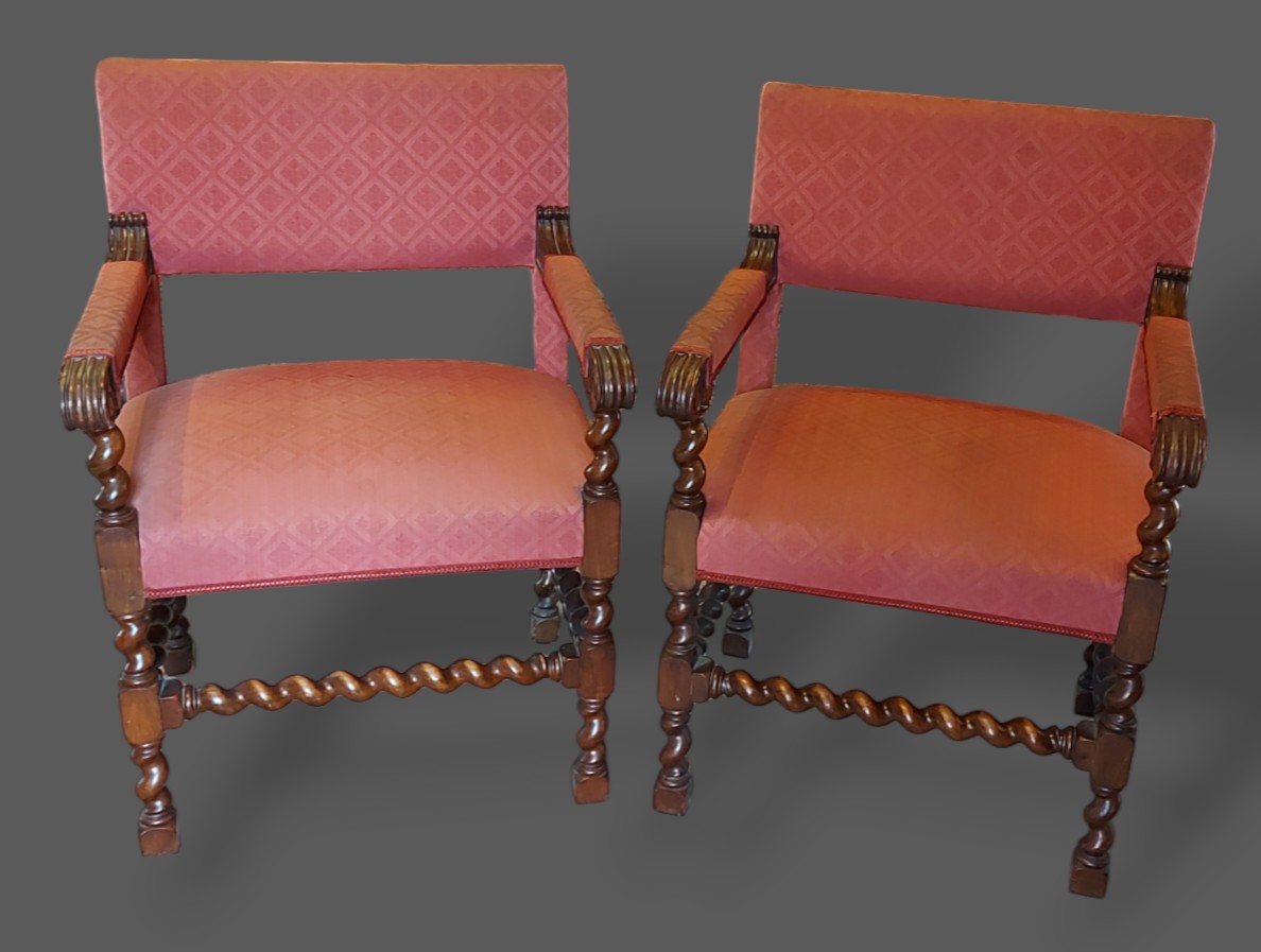 A pair of 19th Century armchairs, each with an upholstered back and seat with barley twist legs