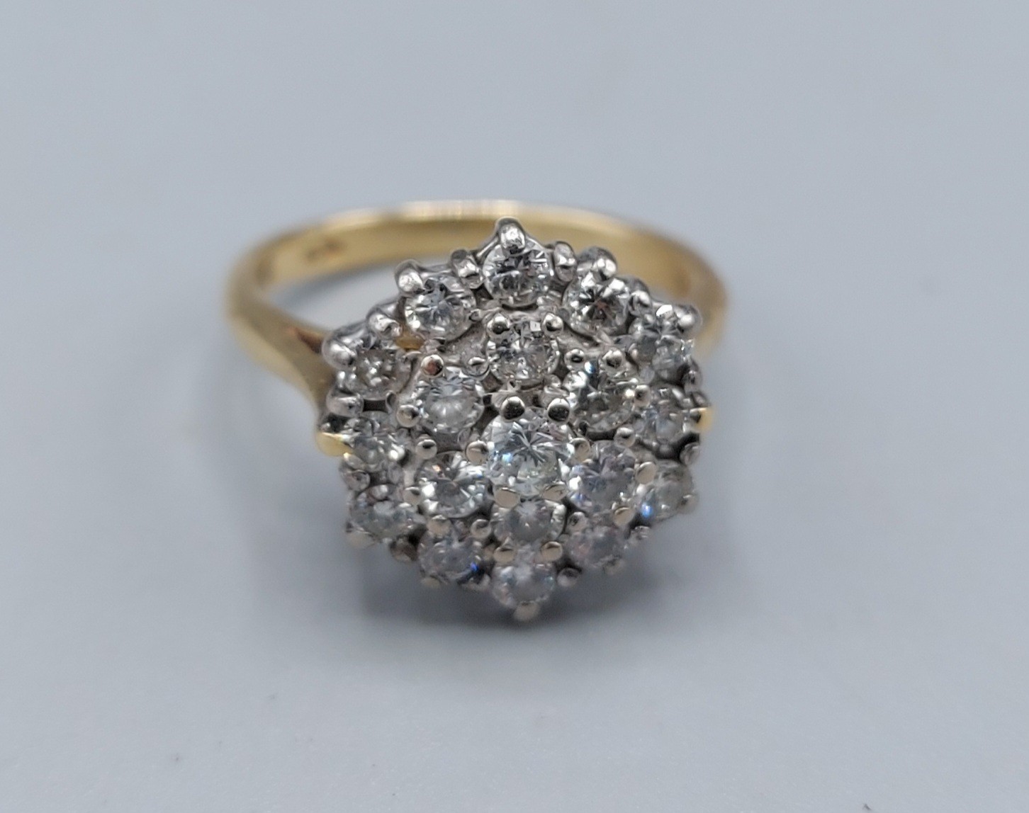 An 18ct gold Diamond cluster ring with a central Diamond surrounded by Diamonds, 4.7gms, ring size I