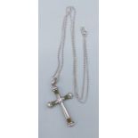 A Sterling silver crucifix pendant set with green stones together with a linked chain