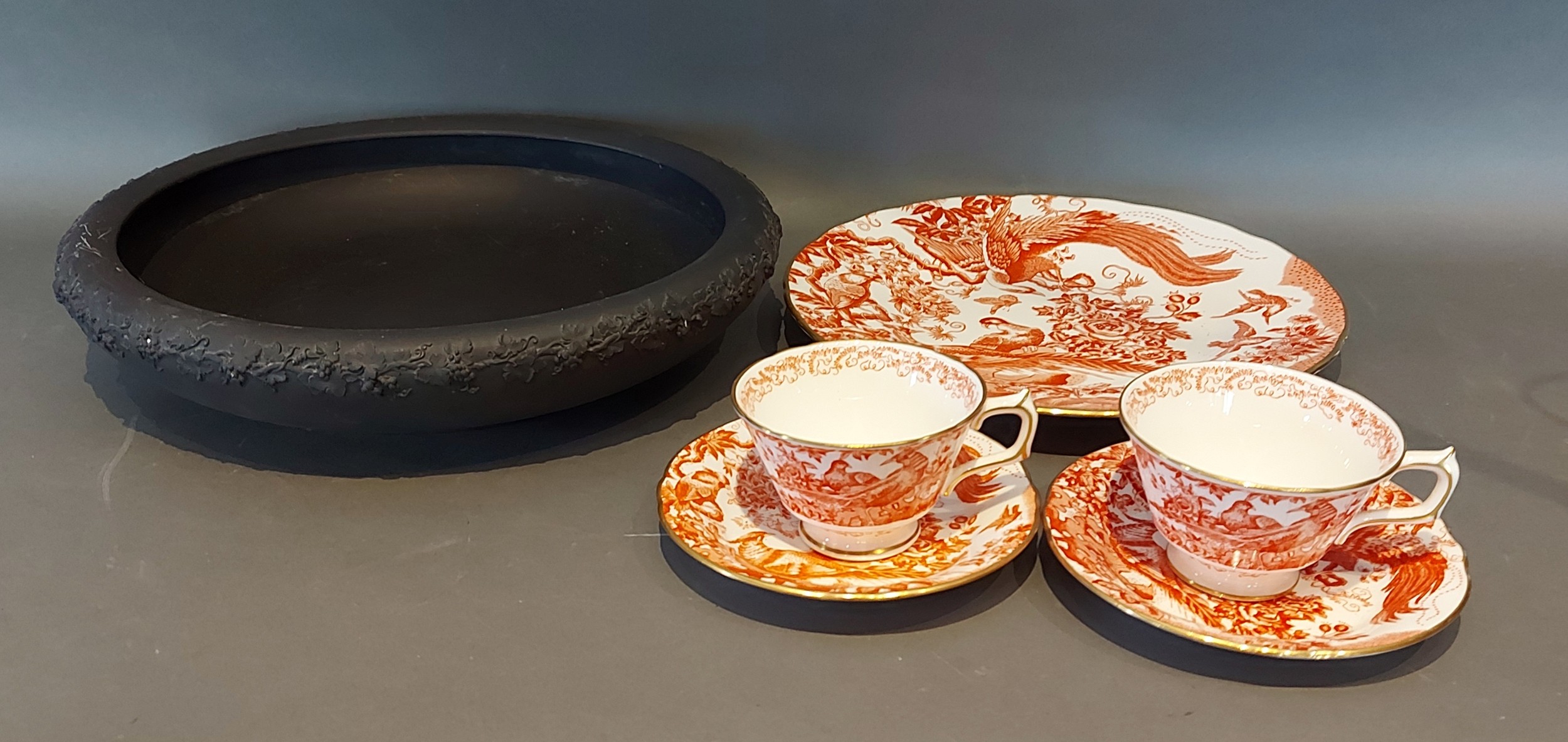 A Wedgwood black basalt shallow bowl, 33cms diameter together with two Royal Crown Derby cups and