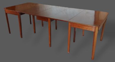 A 19th Century mahogany extending dining table comprising two D shaped ends and a central drop